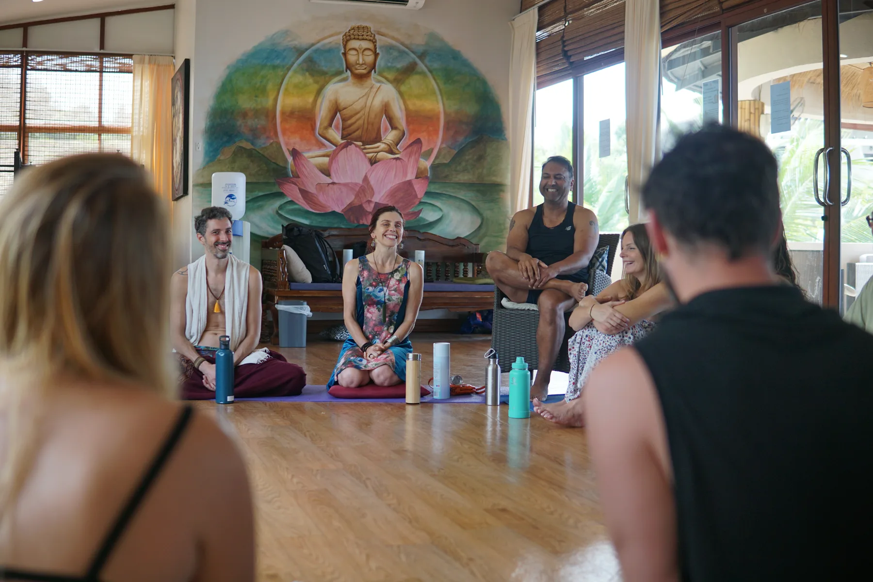 Facilitator Lab session in a Bali yoga shala with Buddha mural