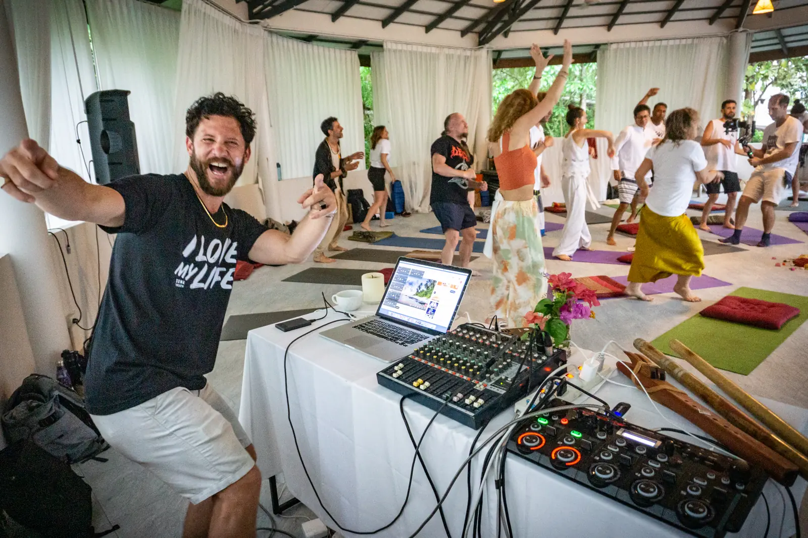 Steve leading a live session from the music desk while the room dances behind him