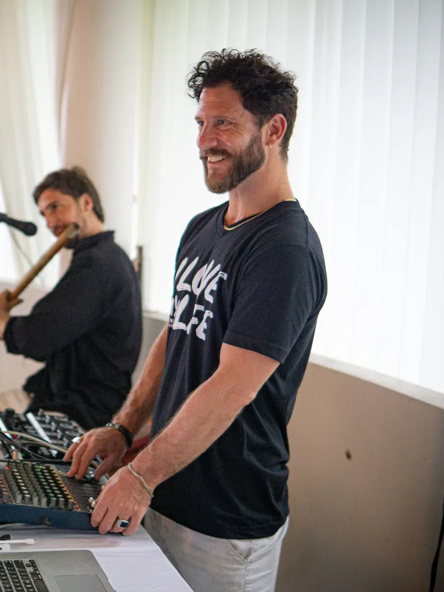 Steve Whitney smiling at the music console while leading a session